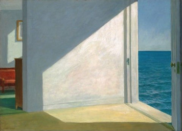 Rooms by the Sea — an open doorway leading directly onto the ocean, sunlight cutting across an empty room